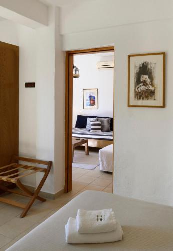 a room with a bed and a room with a couch at 4Elies apartments in Vourvourou