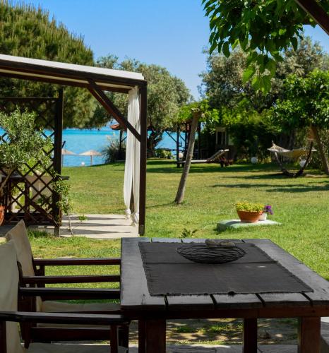 a picnic table with a view of a park at 4Elies apartments in Vourvourou