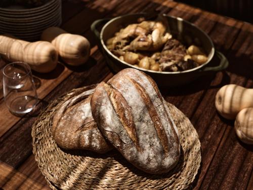 a table topped with bread and a bowl of food at Cielo villas - An Authentic Mediterranean Living in Zakynthos Town
