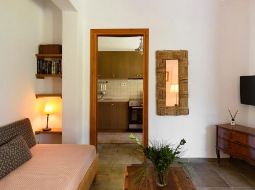 a living room with a couch and a mirror at 4Elies apartments in Vourvourou