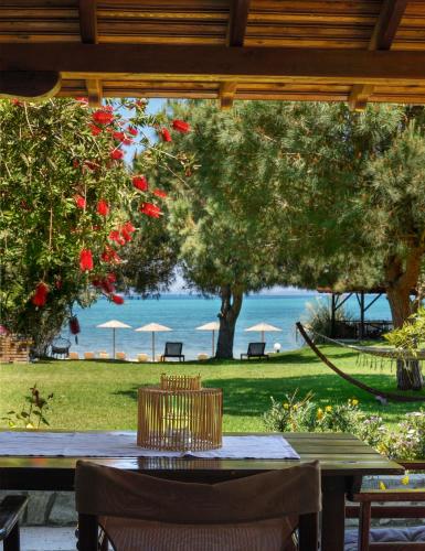 a table and chairs with a view of the ocean at 4Elies apartments in Vourvourou