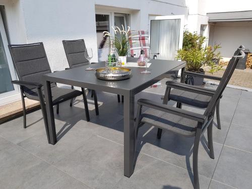 a black dining table and chairs on a patio at Wiesental 
