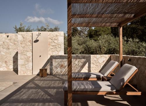 two lounge chairs on the patio of a house at Cielo villas - An Authentic Mediterranean Living in Zakynthos Town