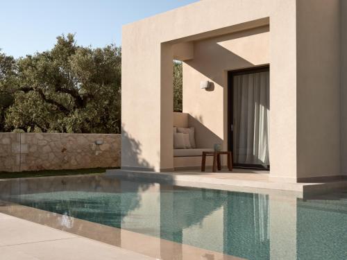 a villa with a swimming pool next to a house at Cielo villas - An Authentic Mediterranean Living in Zakynthos Town