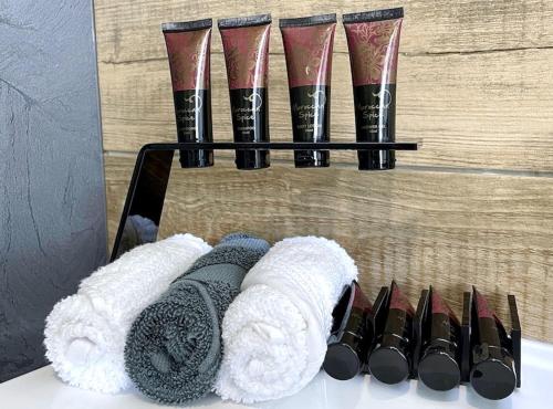a group of towels and a group of pairs of scissors at Ohope Villas with Spa,Sauna,Pool, Adults Only in Ohope Beach
