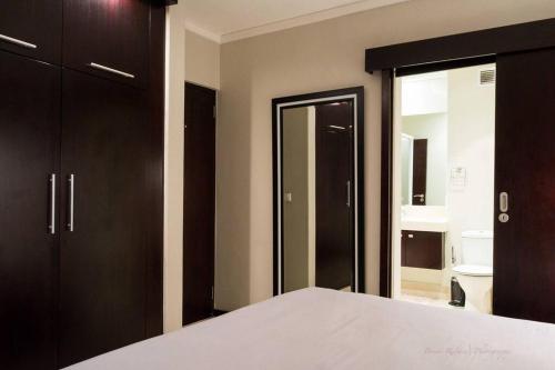 a bedroom with a bed and a bathroom at Icon Luxury Apartments - Central Cape Town in Cape Town