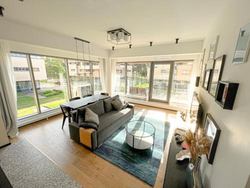 a living room with a couch and a table at New Exclusive 2BD apartment by the sea in Saulkrasti