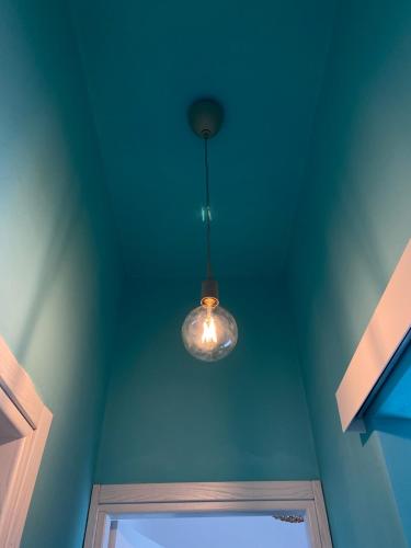 a light hanging from a ceiling with a window at Casa Vacanze , Scoglitti in Scoglitti
