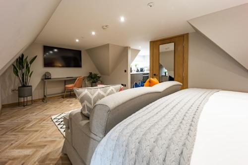 a bedroom with a bed and a living room at No1 Apartments & Bedrooms St Andrews - St Mary's in St. Andrews