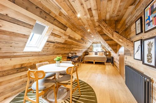 a room with wooden walls and a table and chairs at No1 Apartments & Bedrooms St Andrews - St Mary's in St. Andrews