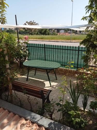 a green bench sitting in front of a pool at N247 - Numana, meraviglioso quadrilocale in posizione strategica in Numana