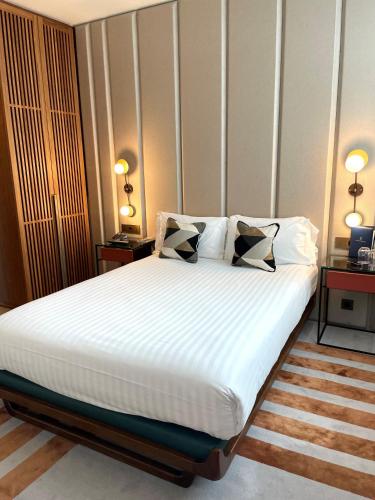 a bedroom with a large bed with two pillows at Maison Bréguet in Paris