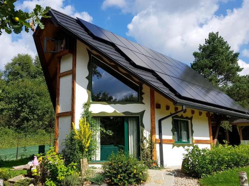 a house with solar panels on the roof at Chata w Rabce - Bajkowa Osada in Rabka