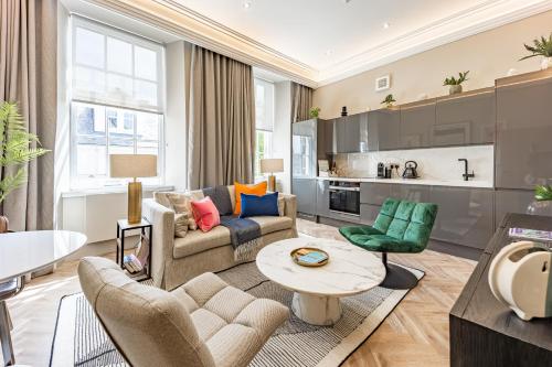 a living room with a couch and a table at No1 Apartments & Bedrooms St Andrews - St Mary's in St. Andrews