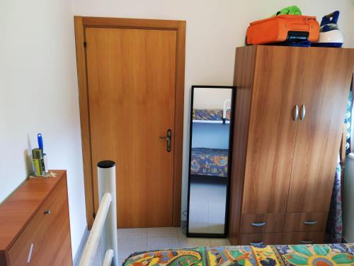 ein Schlafzimmer mit einem Schrank und einem Spiegel neben einem Bett in der Unterkunft LaMagnolia in Fossacesia