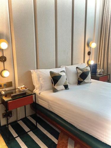 a bedroom with a bed with two pillows on it at Maison Bréguet in Paris
