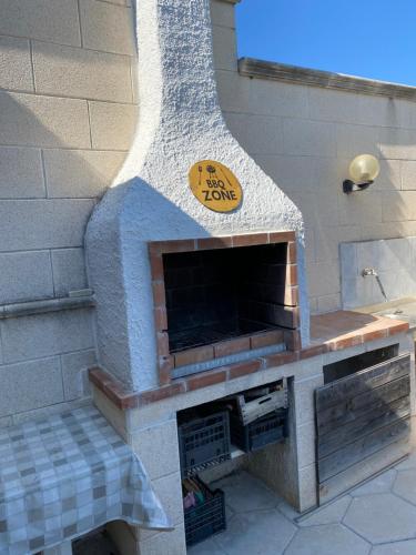 a fake brick fireplace with a sign on it at Villa Viola in Torre Chianca