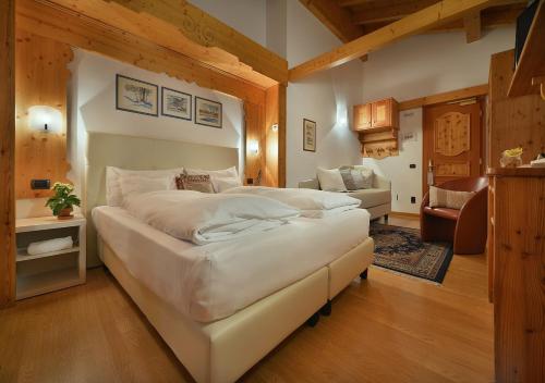 a large bedroom with two beds and a couch at Hotel Posta in Livigno