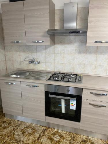 a kitchen with a stove and a sink at Villa Viola in Torre Chianca