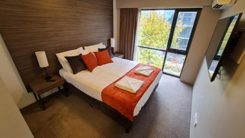 a bedroom with a bed and a large window at 2BR 2Bath L4 Executive Apartment, in City Centre in Canberra