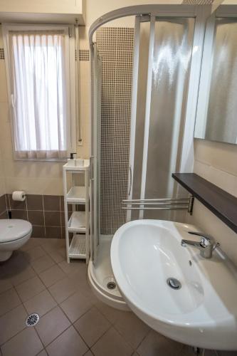 a bathroom with a sink and a shower at Rimini Bay Suites&Residence in Rimini