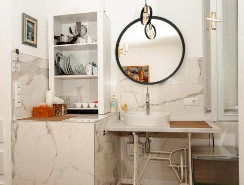 a bathroom with a sink and a mirror at Wilena Apartments in Piran
