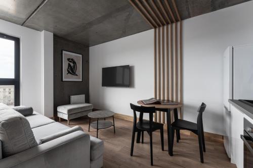 a living room with a couch and a table at Apartamenty Przystanek Morska in Gdynia