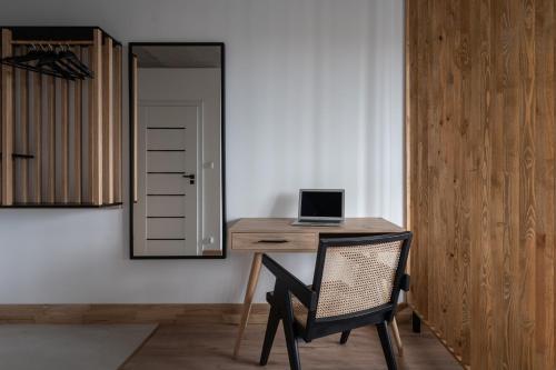 a desk with a laptop computer on it in a room at Apartamenty Przystanek Morska in Gdynia