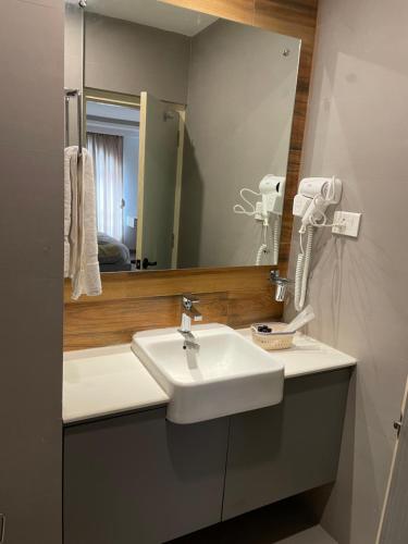a bathroom with a sink and a mirror at Palmo Holiday Apartments in Kathmandu