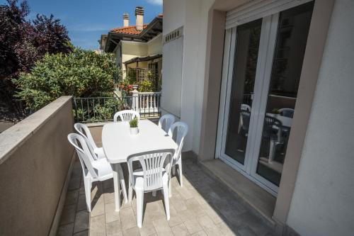 a white table and chairs on a balcony at Rimini Bay Suites&Residence in Rimini