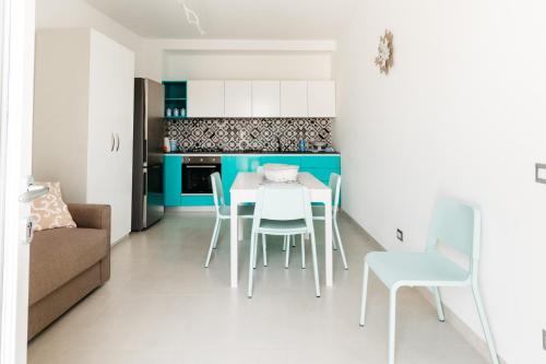 a kitchen and dining room with a table and chairs at Le Isole di Anita in Lipari