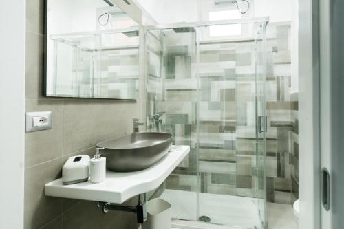 a bathroom with a sink and a glass shower at Le Isole di Anita in Lipari