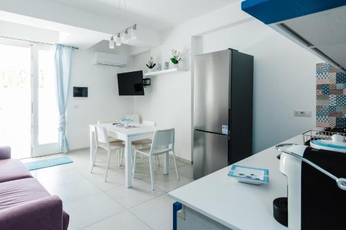 a kitchen with a table and a refrigerator at Le Isole di Anita in Lipari