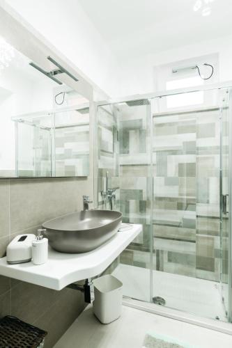 a bathroom with a sink and a glass shower at Le Isole di Anita in Lipari