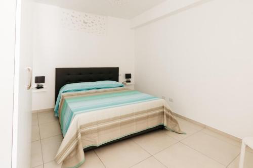 a bedroom with a bed in a white room at Le Isole di Anita in Lipari