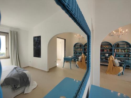a bedroom with a bed and a room with bookshelves at Villa Bella in Torre delle Stelle