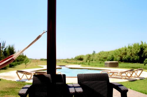 a view of a pool with two chairs and a slide at Casa Maria in Moncarapacho