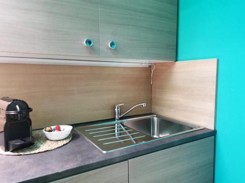 a kitchen with a sink and a counter top at Speciale Tarshito Guesthouse Bari in Bari