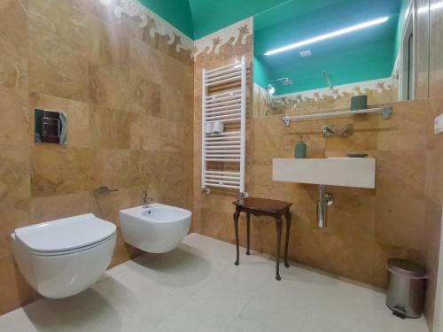 a bathroom with a toilet and a sink at Speciale Tarshito Guesthouse Bari in Bari