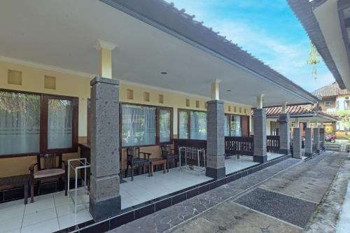a building with a patio with tables and chairs at Dewi Sinta Hotel and Restaurant in Tanah Lot