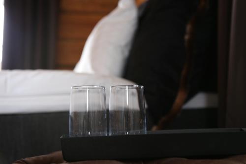 two glasses sitting on a tray on a table at Hemavans Wärdshus in Hemavan