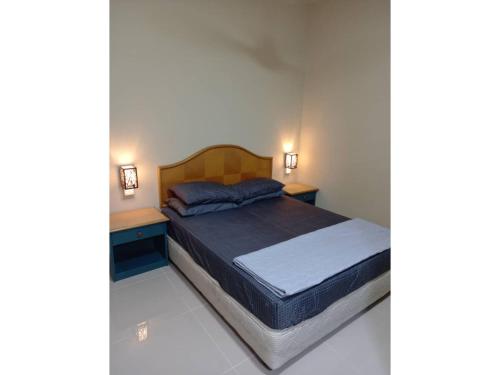a bedroom with a bed and two night stands at Unit B-801 SERI BULAN CONDO HOME SWEET HOME in Port Dickson
