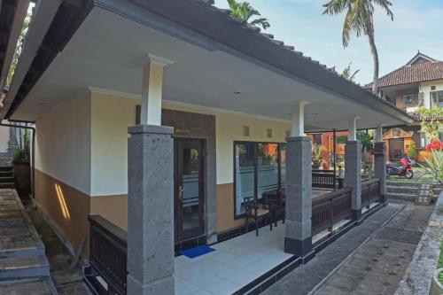 a rendering of a house with a porch at Dewi Sinta Hotel and Restaurant in Tanah Lot