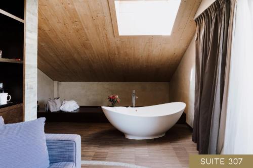 a bathroom with a large white tub in a room at Hotel Lac Salin Spa & Mountain Resort in Livigno