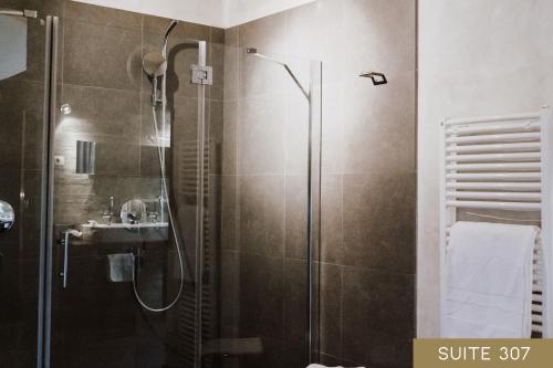 a bathroom with a shower and a sink at Hotel Lac Salin Spa & Mountain Resort in Livigno