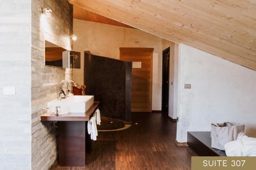 a bathroom with a sink and a mirror at Hotel Lac Salin Spa & Mountain Resort in Livigno
