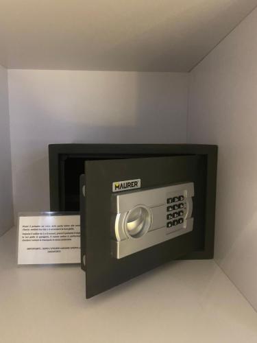 a microwave oven with a box next to it at Residenze Romano Ristorante & Spa - albergo diffuso - RED in Foggia