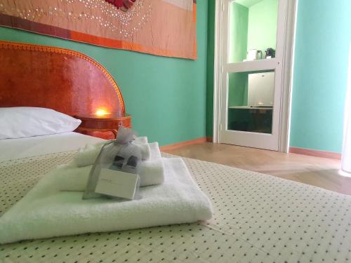 a hotel room with a bed with a sign on it at Speciale Tarshito Guesthouse Bari in Bari