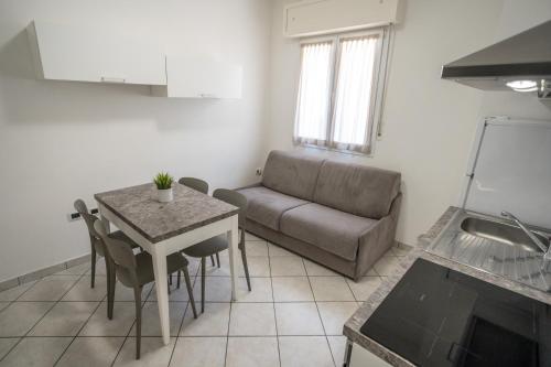 a living room with a couch and a table at Rimini Bay Suites&Residence in Rimini