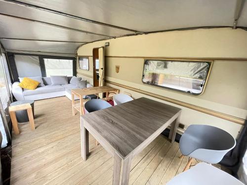 a living room with a table and a couch at Your Camp Kormoran in Hel